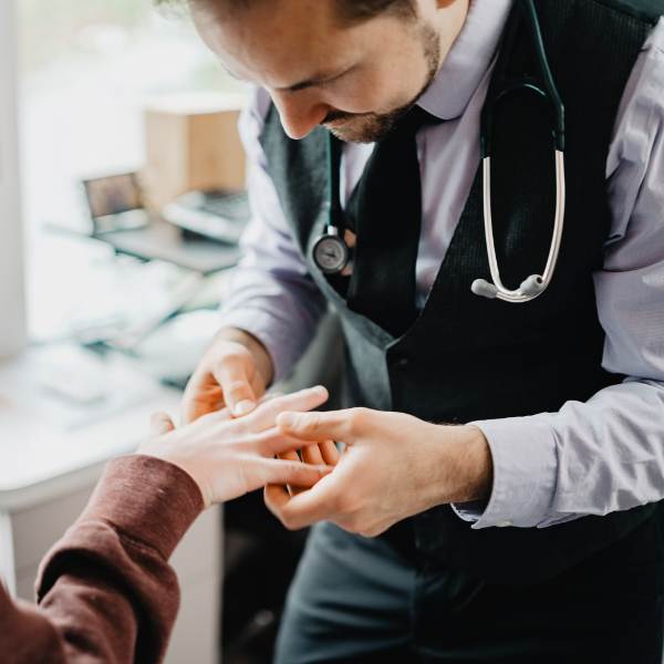 Naturopathic doctor examining patient's hand