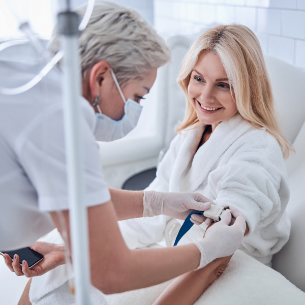 Smiling woman receiving IV therapy